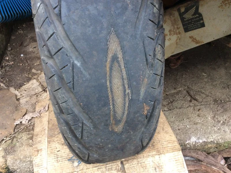 Close-up of a quad-bike tyre worn through to the canvas